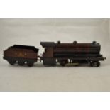 A Bowman O gauge live steam model of a 4-4-0 LMS engine and tender in maroon livery,