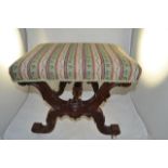 A mid Victorian walnut x-frame stool, white porcelain casters, tapestry seat - W53cm