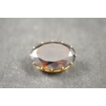 A 14k gold brooch set with an oval smoky quartz - width 4cm