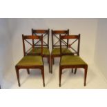 A set of four early 19th century mahogany dining chairs, oval inlay to cross bar, x-frame to back,