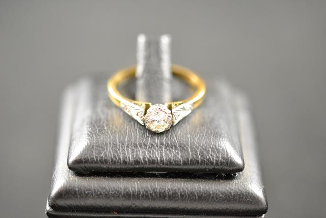 An 18k and platinum ring set with a solitaire diamond, size O