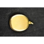 An 18ct gold oval locket - approx. total weight 12.5g. CONDITION REPORT scratched at opening