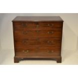 A late 18th century mahogany chest of three long drawers with cast drop handles, bracket feet -