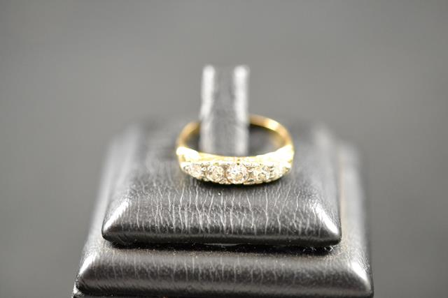 A yellow metal ring set with five diamonds, size J 1/2