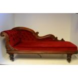 An early 19th century rosewood framed single end chaise longue, red dralon upholstery, lappet turned
