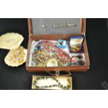 A vintage case containing sundry costume jewellery - necklaces, brooches etc