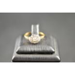 An 18ct gold ring with nine diamonds in Art Deco style setting - size M 1/2. CONDITION REPORT good