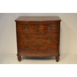 An early 19th century mahogany bow fronted chest of two short and two long drawers, brass ring