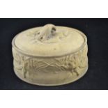 A 19th century buff terracotta lidded game dish with game bird decoration, glazed liner - L26cm