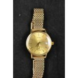 An Omega yellow metal gentleman's wristwatch on 9ct gold mesh bracelet, presented by the State of