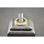 An 18ct gold ring with seven channel set diamonds - size O 1/2. CONDITION REPORT good condition