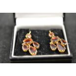 A pair of 9ct gold drop earrings, each set with five garnets. CONDITION REPORT good condition