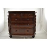 An early 19th century mahogany miniature chest of two short and three long graduated drawers, bobbin