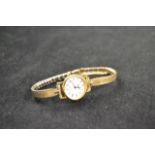 A Longines quartz ladies wristwatch in gold plated stainless steel case with engraved bracelet