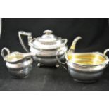 A late Georgian silver three piece tea set comprising teapot, sugar bowl and cream jug, shell and