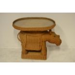 A mid 20th Century novelty wicker occasional table in the form of a rhinoceros with green eyes,