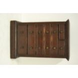 A late 19th/early 20th century pine miniature chest of two short and five long graduated drawers,