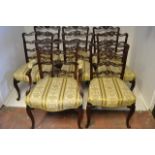 A set of eight late 19th/early 20th century Chippendale style mahogany ladder back chairs with