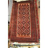 A blue and red ground Middle Eastern rug, diamond design to centre, multiple border, coloured