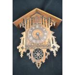 A late 19th/early 20th Century Bavarian carved oak cased cuckoo clock, Roman numerals to dial,