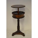 An early 19th Century rosewood circular teapoy, rising lid with amboyna cross banding, revealing