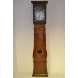 A 19th Century French longcase clock, circular enamel dial surmounted by embossed metal religious