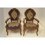 A pair of late 19th/early 20th century continental walnut armchairs, floral crest rail, tapestry
