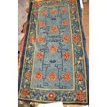 A Sino-Tibetan blue ground rug, floral design - 175x95cm. CONDITION REPORT Slight wear and