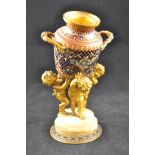 A 19th century French gilt metal figure group depicting three cherubs tilting a cloisonne vase,