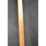 A brewer's measuring stick with brass mount, inscribed 'L Lumley and Co Ltd Makers 1 America