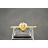 A 15ct gold bar brooch mounted with heart shaped locket with central gypsy set diamond - L5.1cm,