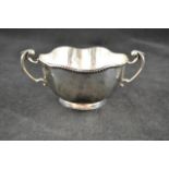 A Mappin and Webb silver two handled sugar bowl with beaded edge, London 1911, height 6cms, diam.