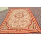 A French style tapestry carpet with centre floral roundel and floral decoration to corners -