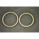 A 9ct rose gold bangle of tubular form - diam 9cm, together with another 9ct gold bangle - diam 8.