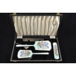 A mid 20th Century silver and painted enamel dressing table set comprising hand mirror, two