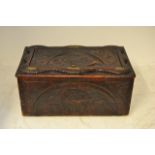 An 18th/early 19th Century hardwood and pine chest, carved dragon to lid, applied brass crowns,