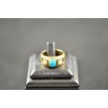 An 18ct gold ring set with oval cabochon turquoise and two diamonds - size L, approx gross weight