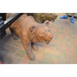 A Black Forest carved hardwood brown bear, painted saddle and face mask to rear - H70cm, L135cm