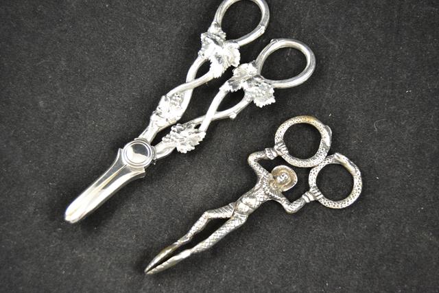 A pair of silver sugar tongs, maker ME, of harlequin design, together with a pair of silver plated
