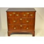 An 18th Century chest of two short and two long drawers, veneered in walnut with herringbone