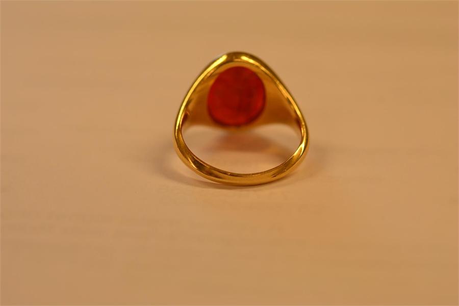 A yellow metal signet ring set with carnelian intaglio carved with Roman style figure - size L 1/