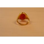 A yellow metal signet ring set with carnelian intaglio carved with Roman style figure - size L 1/