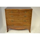 An early 19th Century mahogany chest of two short and three long graduated drawers, reeded edge to