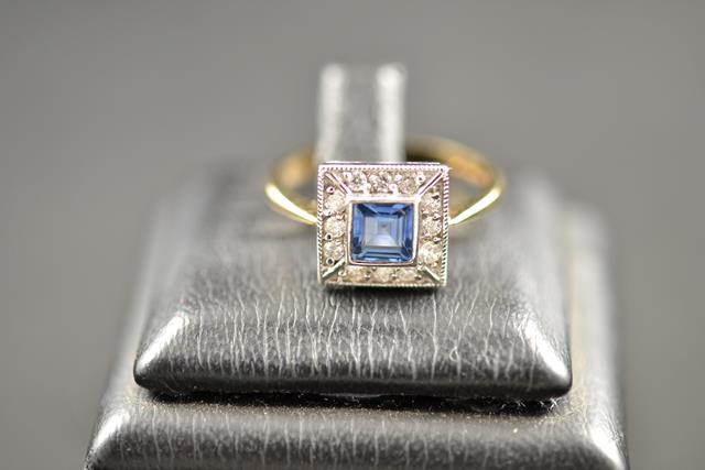 A 9ct gold ring set with square cut kan cha sapphire surrounded by diamonds, size O. CONDITION