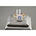 A 9ct gold ring set with square cut kan cha sapphire surrounded by diamonds, size O. CONDITION