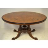 A Victorian oval figured walnut loo table, ebonised edge, quadruple column ending in four cabriole