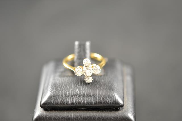 An 18ct gold and platinum ring with five diamonds in cross setting - size K 1/2, approx gross weight