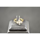 An 18ct gold and platinum ring with five diamonds in cross setting - size K 1/2, approx gross weight