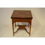 A late 19th/early 20th Century inlaid mahogany envelope card table, counter wells, gilt edged