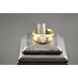 An 18ct gold ring set with central star sapphire and two diamonds, size Q. CONDITION REPORT